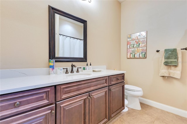 bathroom with tile patterned floors, vanity, and toilet