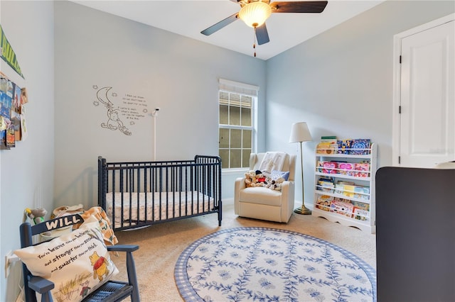 bedroom featuring carpet flooring, ceiling fan, and a crib