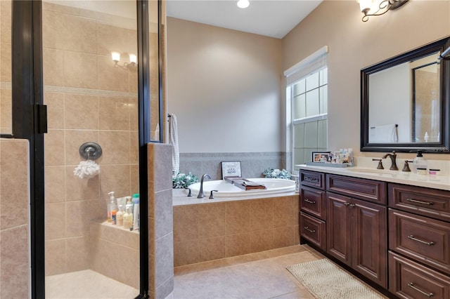 bathroom with tile patterned flooring, vanity, and independent shower and bath