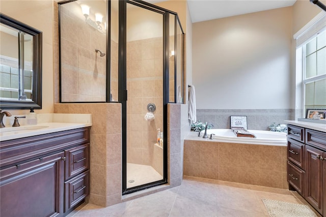 bathroom featuring tile patterned floors, vanity, and shower with separate bathtub