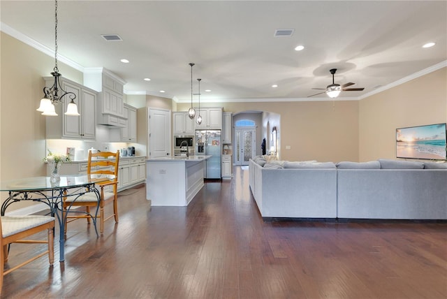 living room with ceiling fan, dark hardwood / wood-style flooring, and crown molding