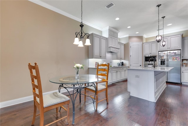 kitchen featuring a center island with sink, hanging light fixtures, stainless steel refrigerator with ice dispenser, and an inviting chandelier