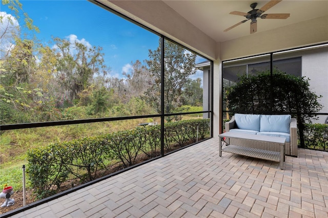 unfurnished sunroom with ceiling fan