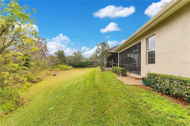 view of yard featuring a sunroom