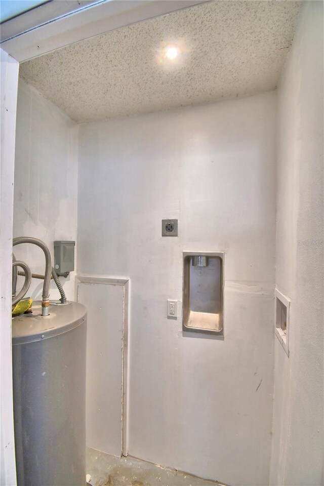 laundry room with water heater, a textured ceiling, washer hookup, and electric dryer hookup