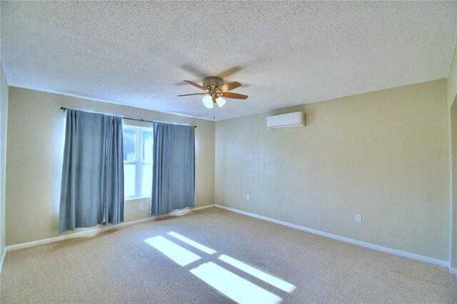 unfurnished room featuring ceiling fan, carpet flooring, a textured ceiling, and a wall mounted air conditioner