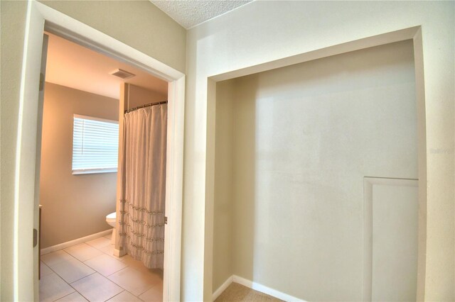 corridor with light tile patterned floors