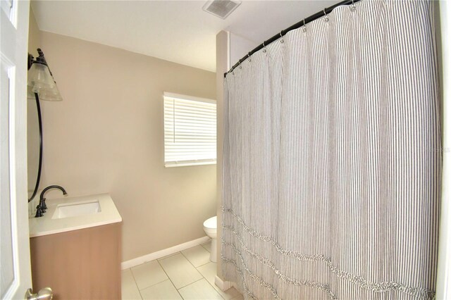 bathroom featuring vanity, tile patterned flooring, and toilet