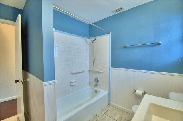 full bathroom featuring vanity, tiled shower / bath combo, toilet, and tile patterned flooring