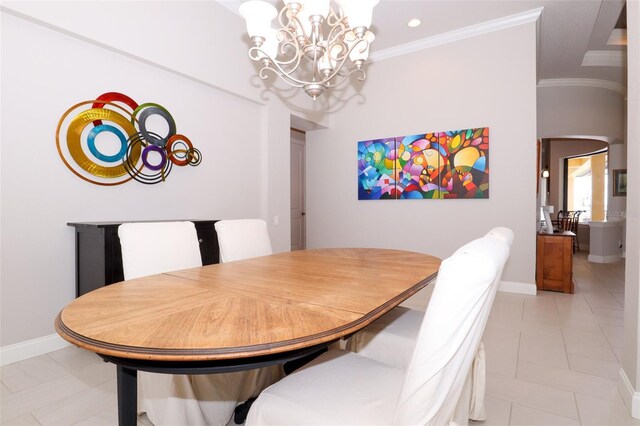 dining area with light tile patterned floors, a notable chandelier, and ornamental molding