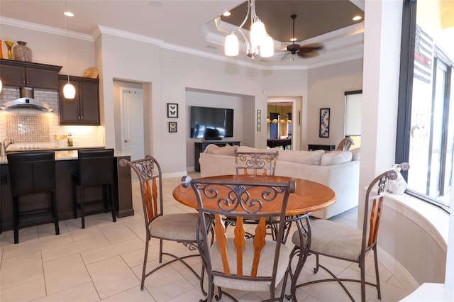 dining area with light tile patterned floors, recessed lighting, a raised ceiling, ornamental molding, and baseboards