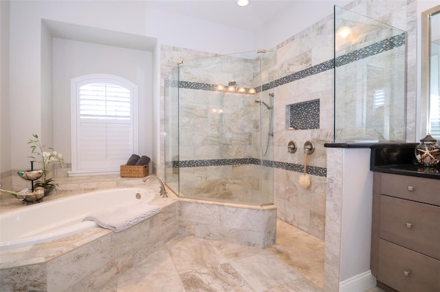 full bathroom featuring walk in shower, a bath, and vanity