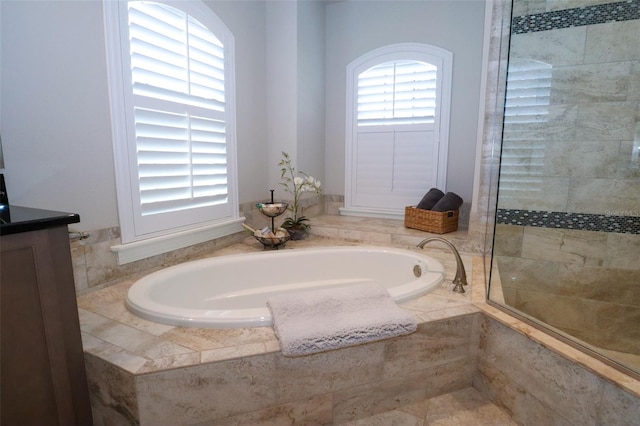 bathroom featuring vanity, a wealth of natural light, and separate shower and tub