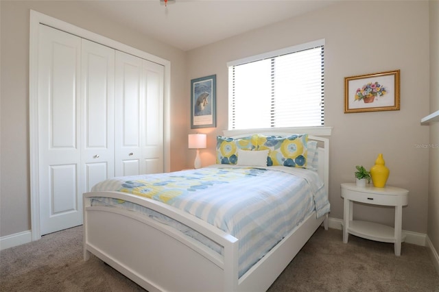 bedroom with dark carpet and a closet