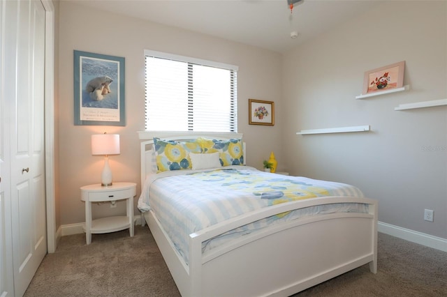 carpeted bedroom featuring baseboards