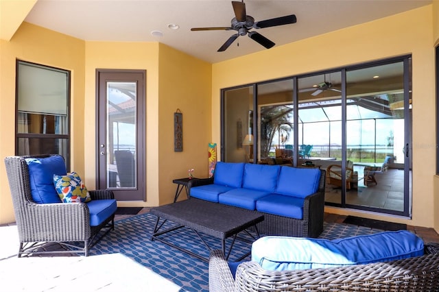 view of patio / terrace with ceiling fan, a lanai, and an outdoor living space