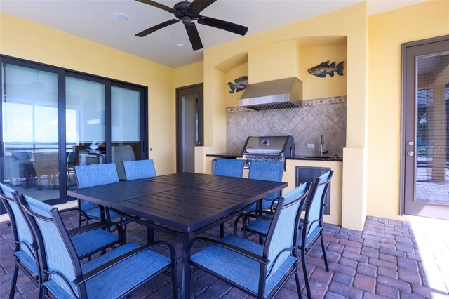 dining space with ceiling fan, sink, and a healthy amount of sunlight