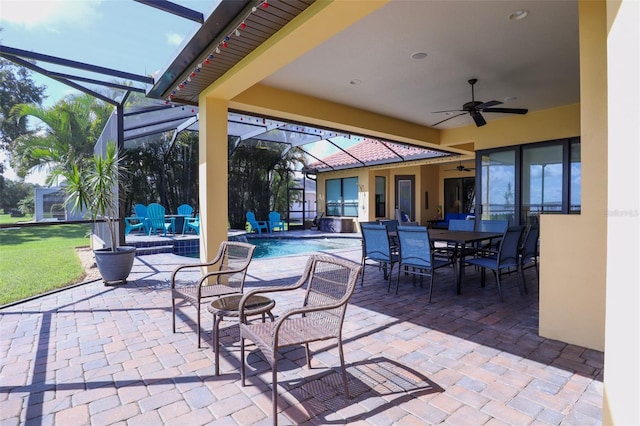 view of patio featuring ceiling fan and glass enclosure