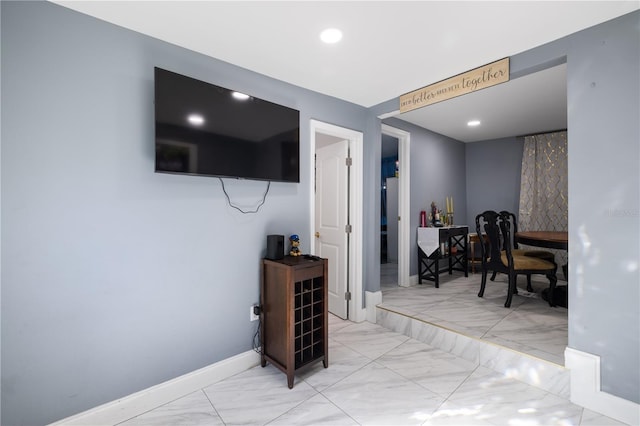 interior space with marble finish floor, recessed lighting, and baseboards