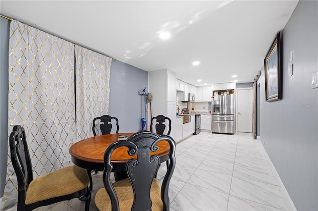 dining area with recessed lighting, marble finish floor, and baseboards