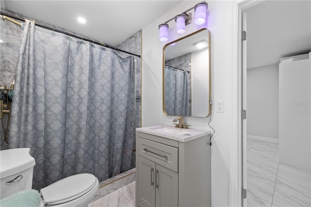 bathroom with toilet, marble finish floor, and vanity