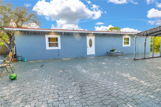 back of property with stucco siding