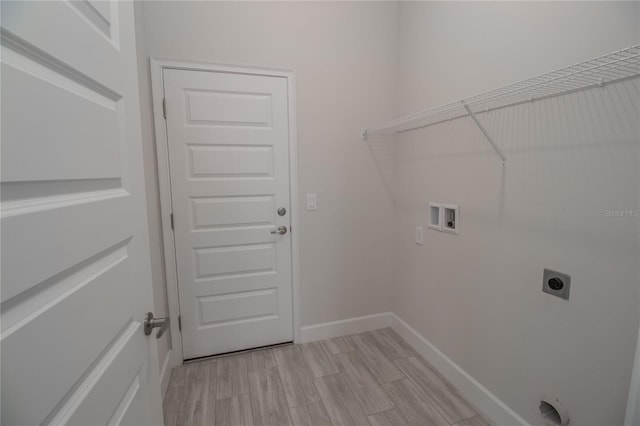 clothes washing area with electric dryer hookup, light wood-type flooring, and hookup for a washing machine