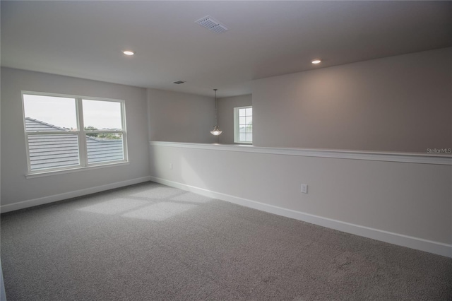 spare room with light colored carpet