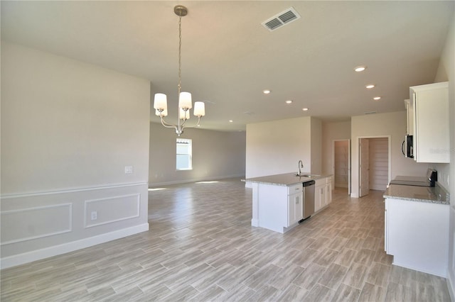 kitchen with a sink, open floor plan, stainless steel appliances, visible vents, and white cabinets