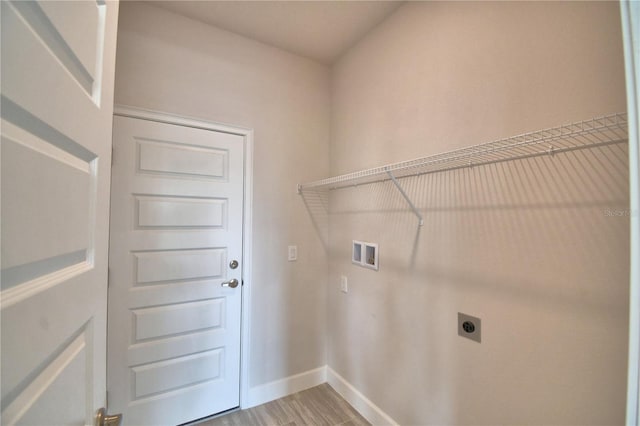 washroom featuring hookup for an electric dryer, light wood-type flooring, baseboards, laundry area, and washer hookup