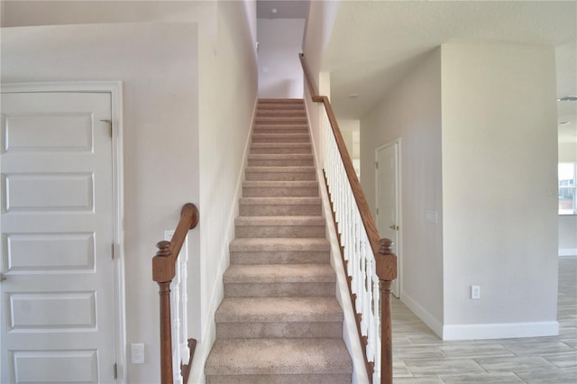 stairway featuring baseboards