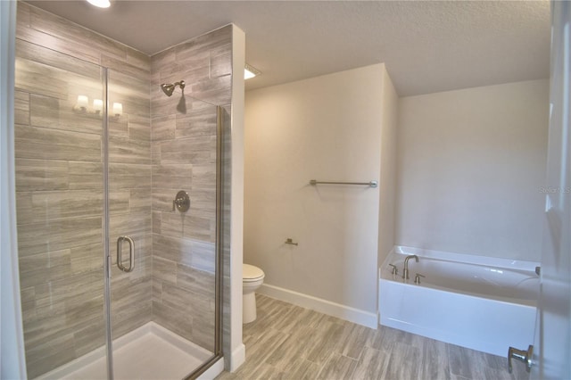 bathroom with a shower stall, baseboards, wood finished floors, toilet, and a garden tub