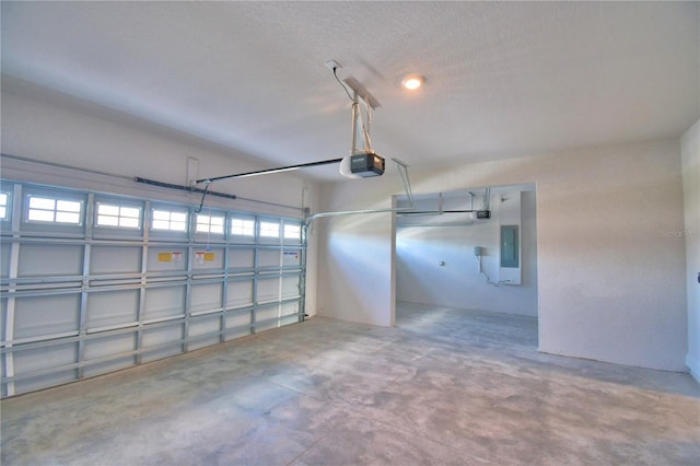garage with electric panel and a garage door opener