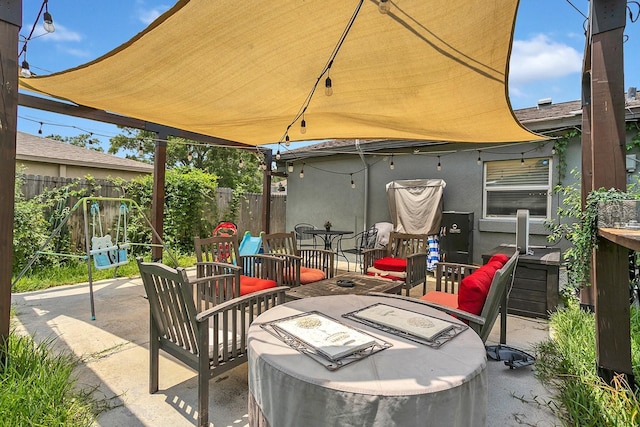 view of patio featuring fence and outdoor lounge area