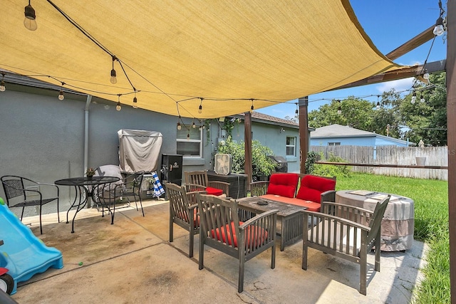 view of patio featuring fence, outdoor dining area, and outdoor lounge area