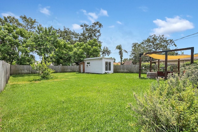 view of yard with an outdoor structure and a fenced backyard