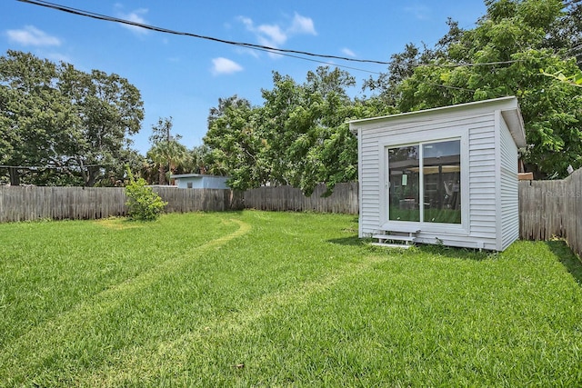 view of yard featuring an outbuilding and a fenced backyard