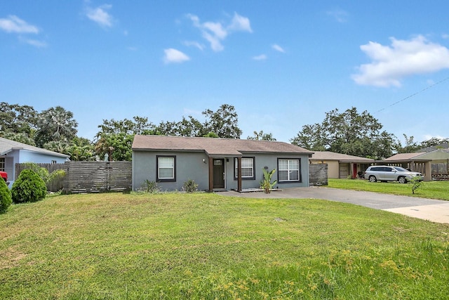 single story home featuring fence, a front lawn, stucco siding, and concrete driveway