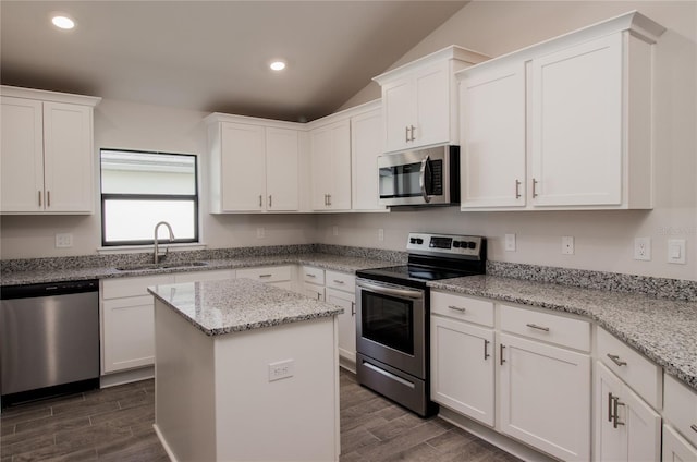 kitchen with light stone counters, sink, stainless steel appliances, and white cabinets