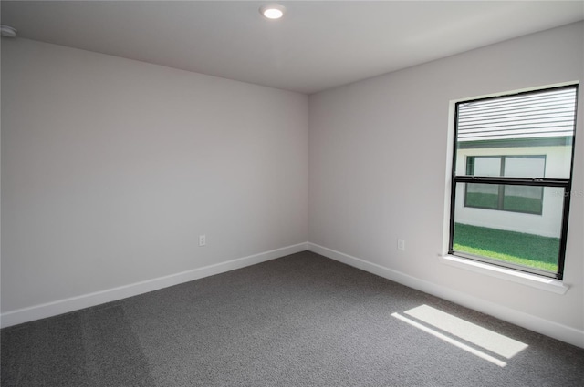 unfurnished room featuring carpet