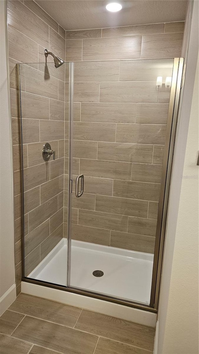 bathroom featuring a shower with shower door