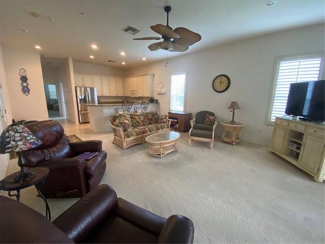 living room with light carpet and ceiling fan