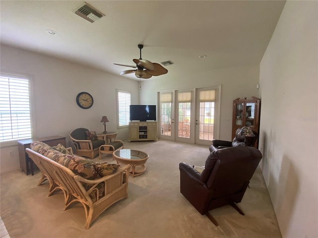 living room with ceiling fan, light carpet, and french doors