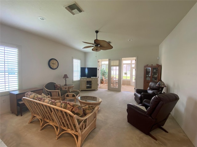 carpeted living room with ceiling fan