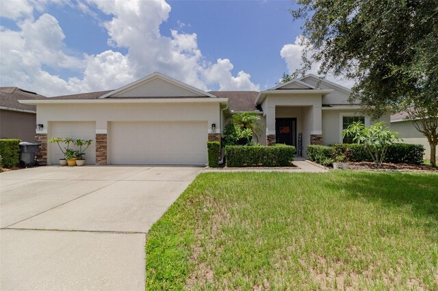 view of front facade with a front yard and a garage