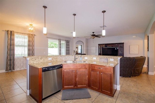 kitchen with visible vents, open floor plan, hanging light fixtures, stainless steel dishwasher, and a sink