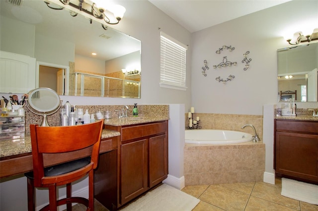 full bath with two vanities, a sink, tile patterned flooring, a shower stall, and a bath