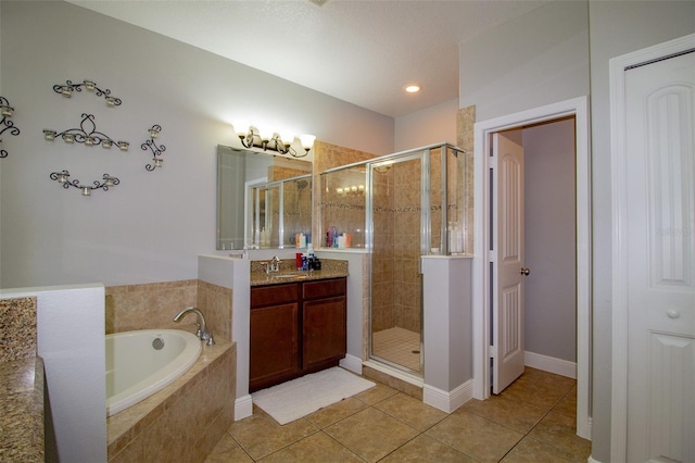 full bathroom featuring a bath, a stall shower, tile patterned flooring, and vanity