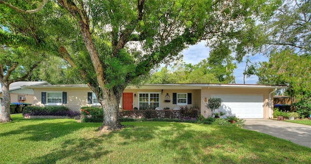 ranch-style home featuring a garage and a front yard