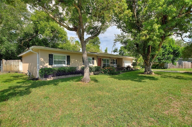 single story home featuring a front lawn